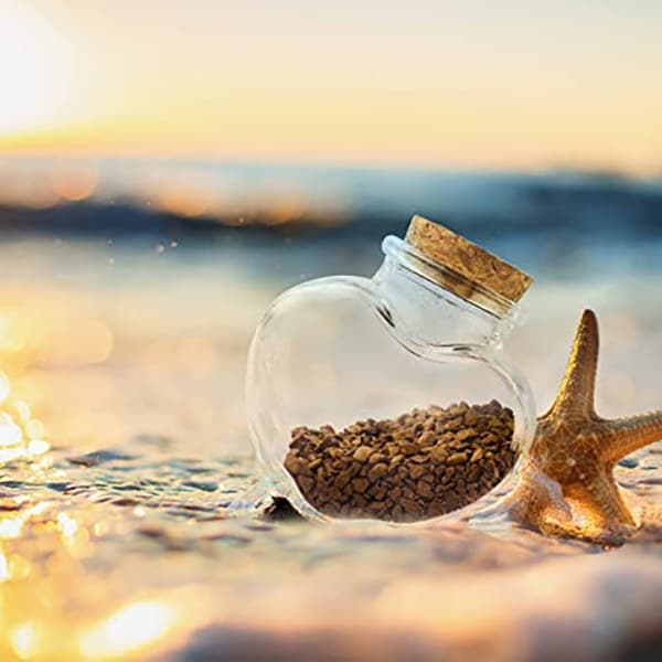 heart shaped candle jar at seashore