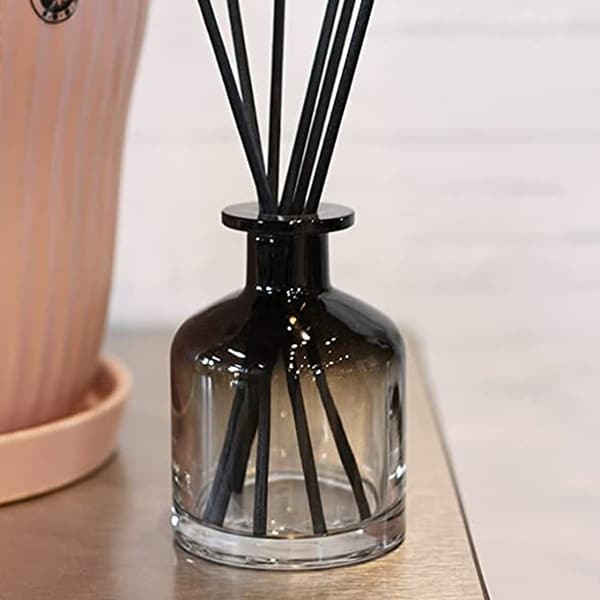 empty reed diffuser bottle in living room