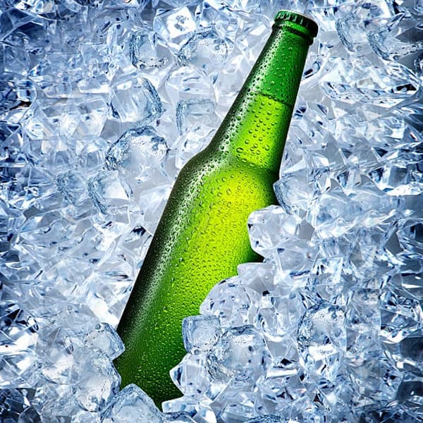 green glass beer bottle in ice